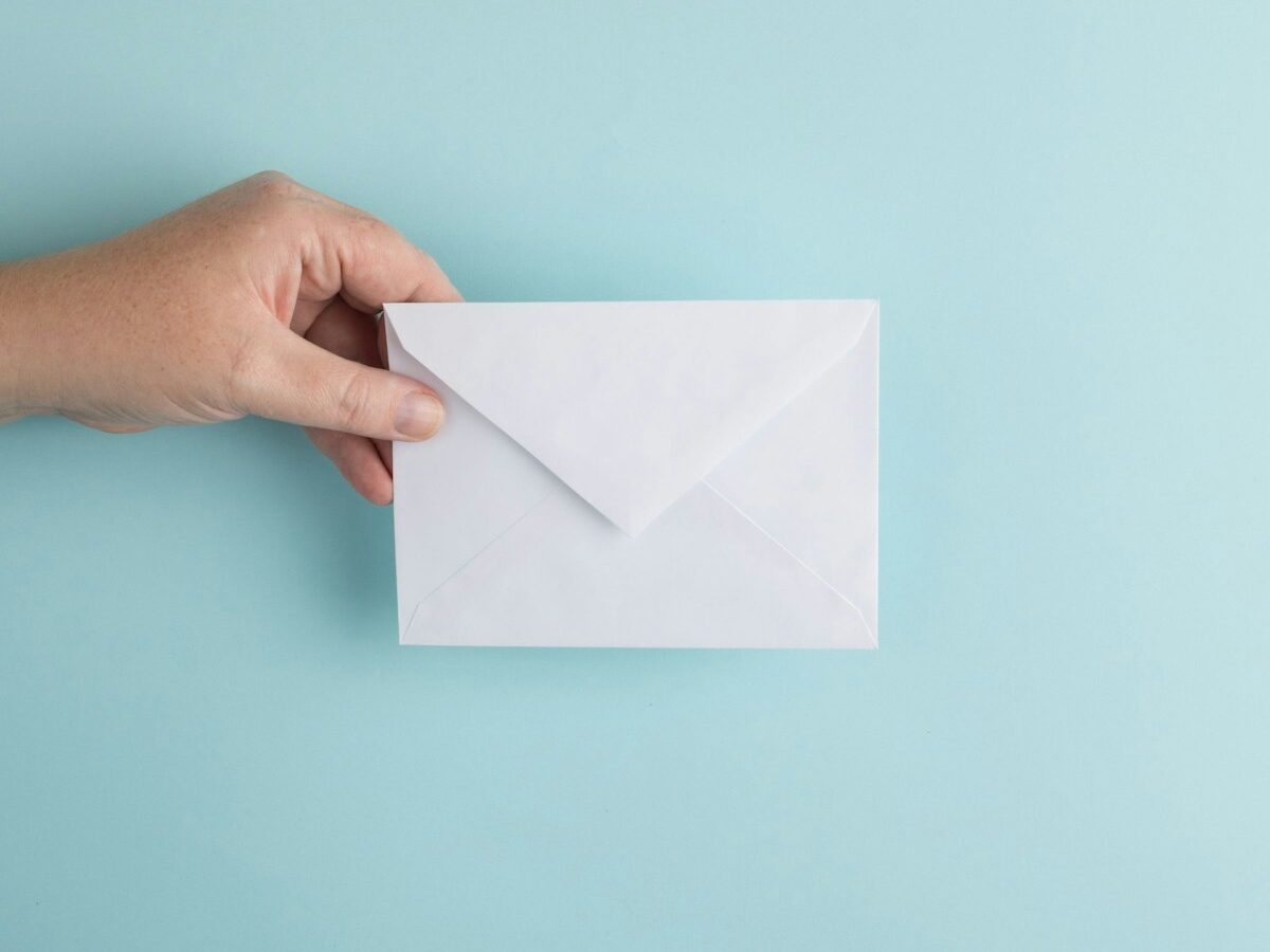 person showing white envelope