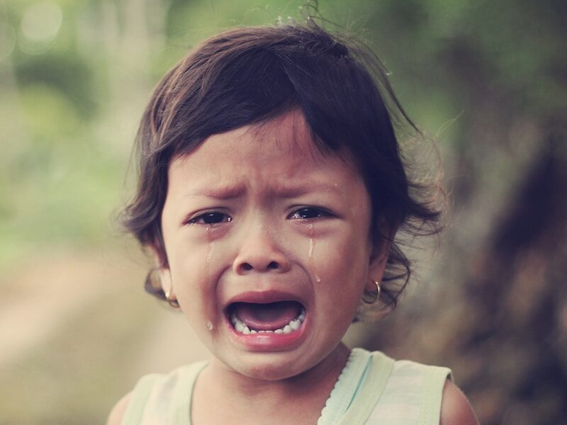 selective focus photography of girl crying
