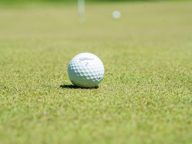 white golf ball on green grass field during daytime