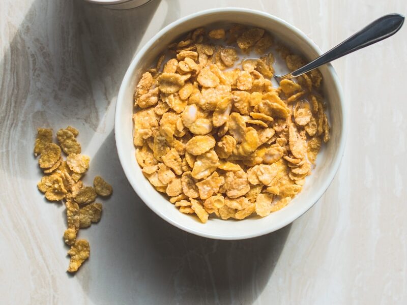 ceramic bowl filled with cereals and spoon