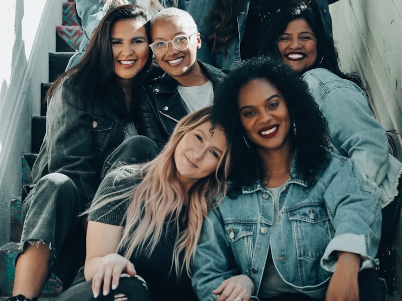 2 women sitting on black chair