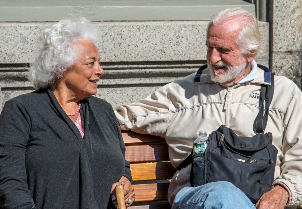 a man and a woman sitting on a bench