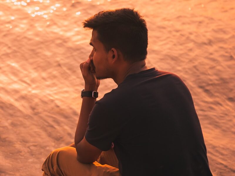 a man sitting on a rock