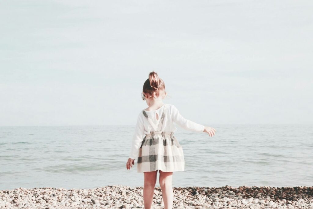 girl walking towards the sea