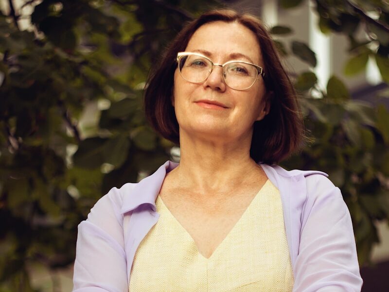 woman in white long sleeve shirt smiling