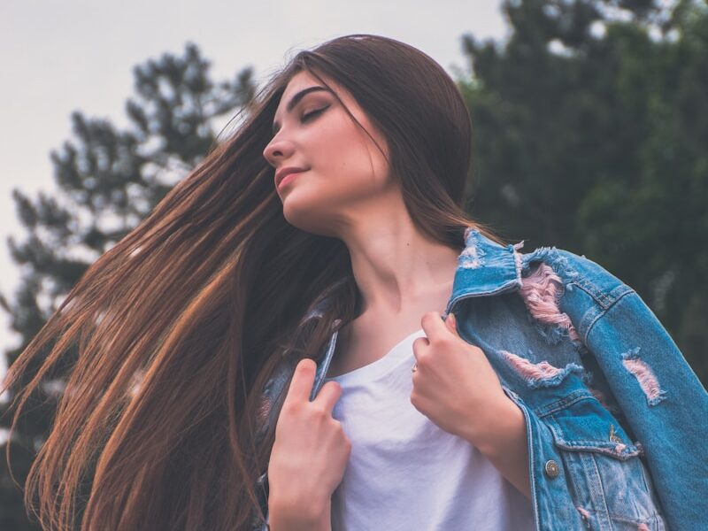woman holding her white shirt flipping hair