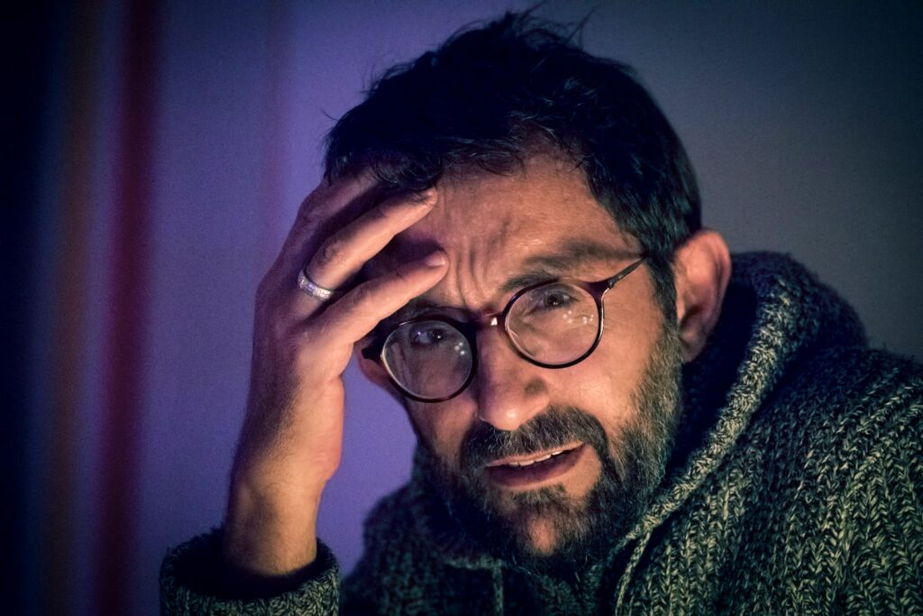 man in grey sweater and pair of black framed eyeglasses