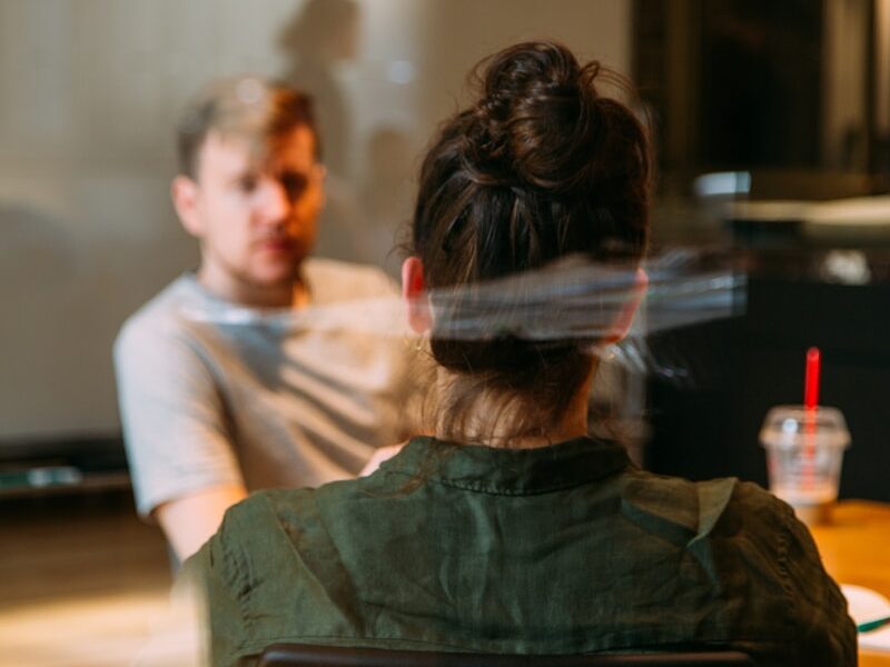 person sitting in a chair in front of a man