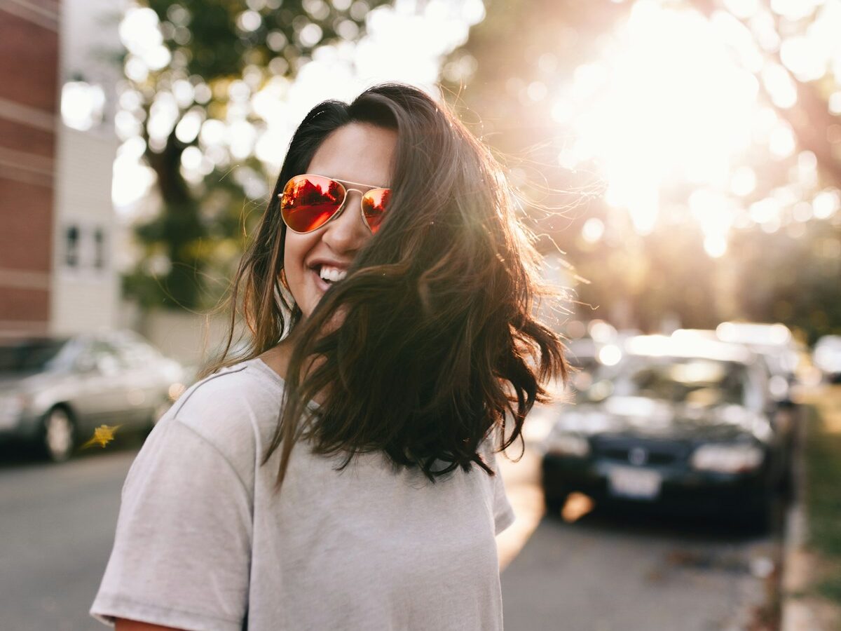woman wearing white T-shirt smiling