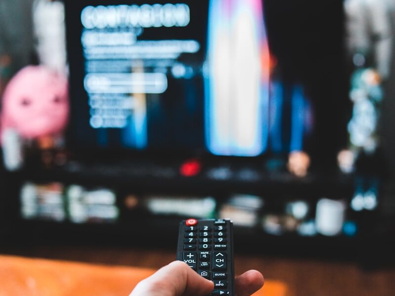 person holding black remote control