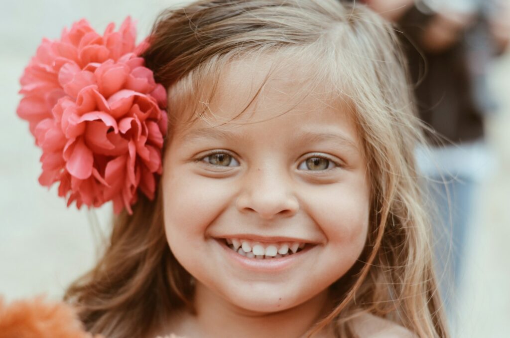 girl with red flower on her ear