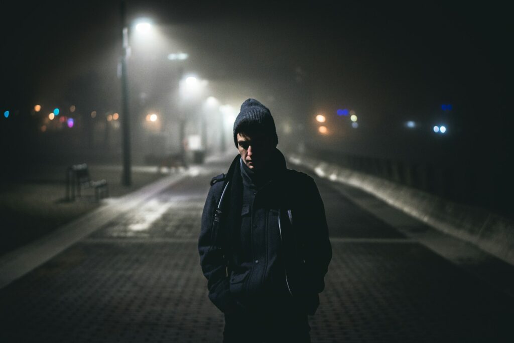 man standing near street lights