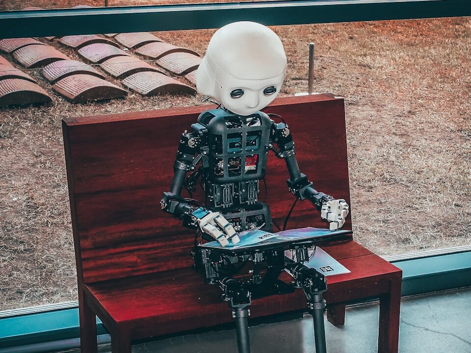 black and white robot toy on red wooden table