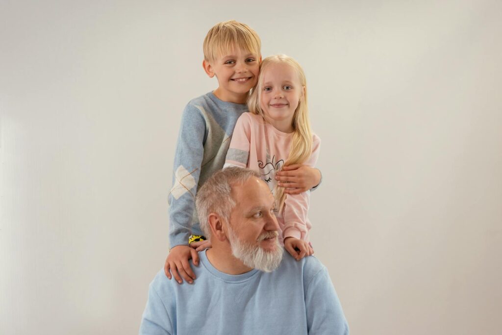Joyful family portrait of grandfather with grandchildren creating a warm bond.