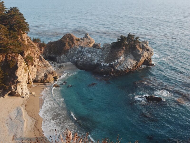 a view of the ocean from the top of a hill
