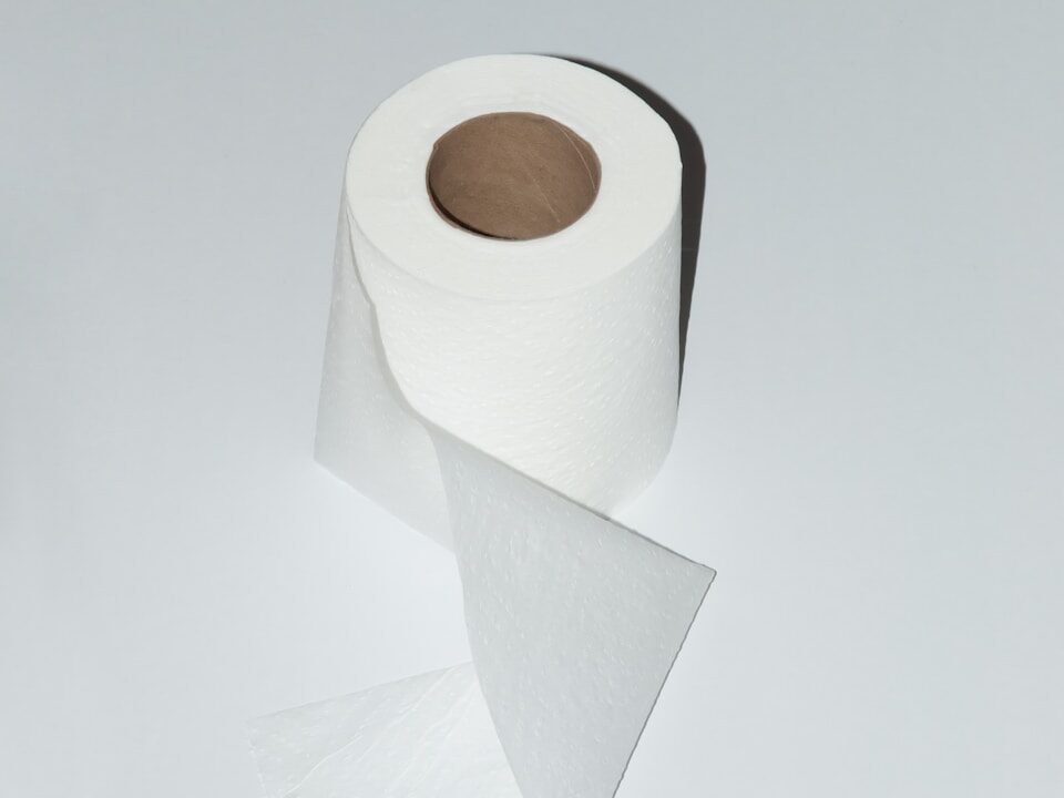 white toilet paper roll on white table