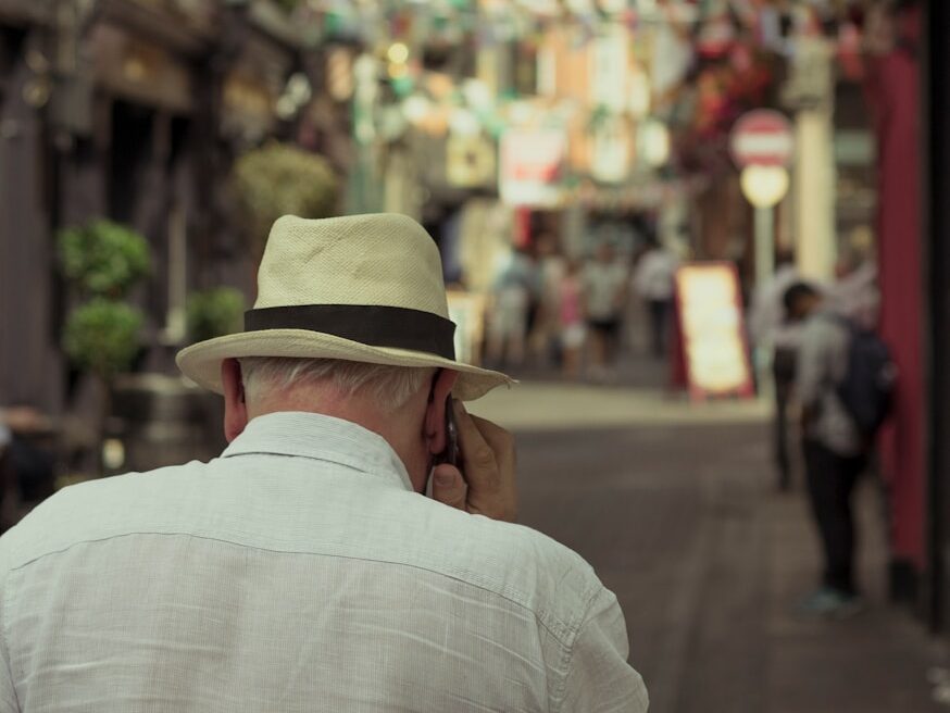 shallow focus photo of man using mobile phone