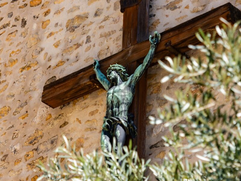 crucifix beside brown wall