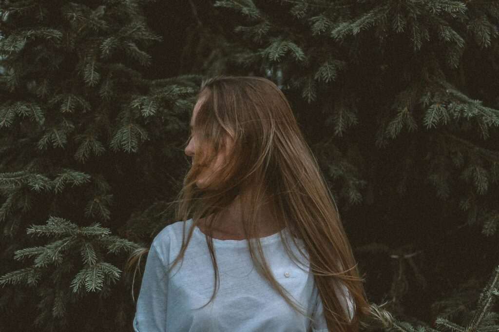 woman wearing white shirt near tree