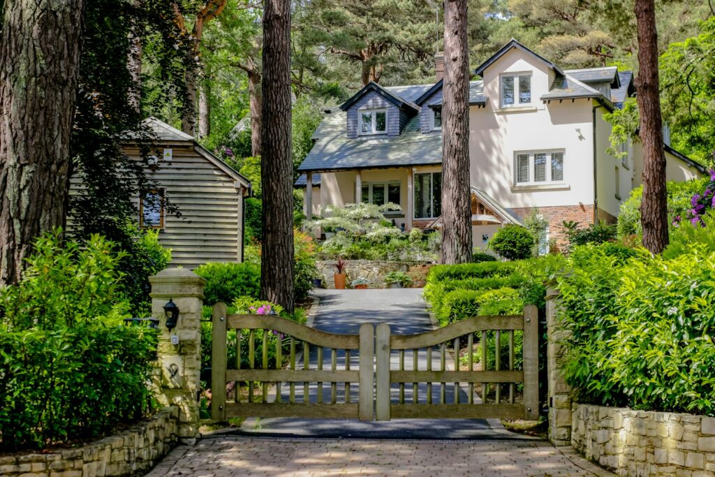A driveway with a gate leading to a house