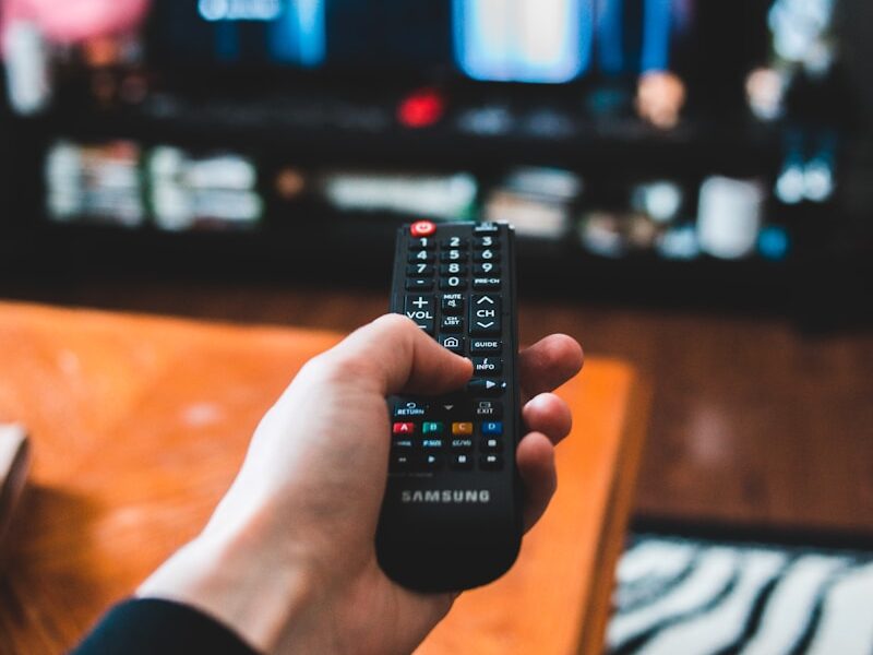 person holding black remote control