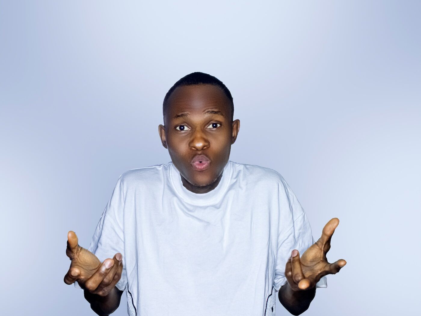 a young boy holding his hands up