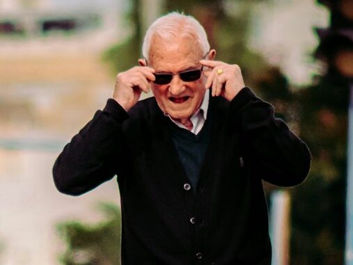 man in black jacket and gray pants standing on street during daytime