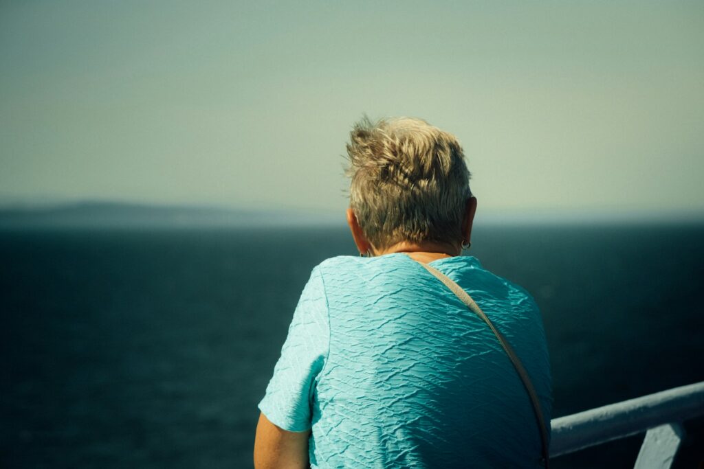 man in blue shirt sitting on boat during daytime